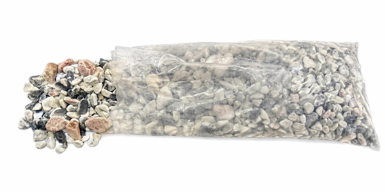 Bag of multicolored stones with a decorative top on a white background